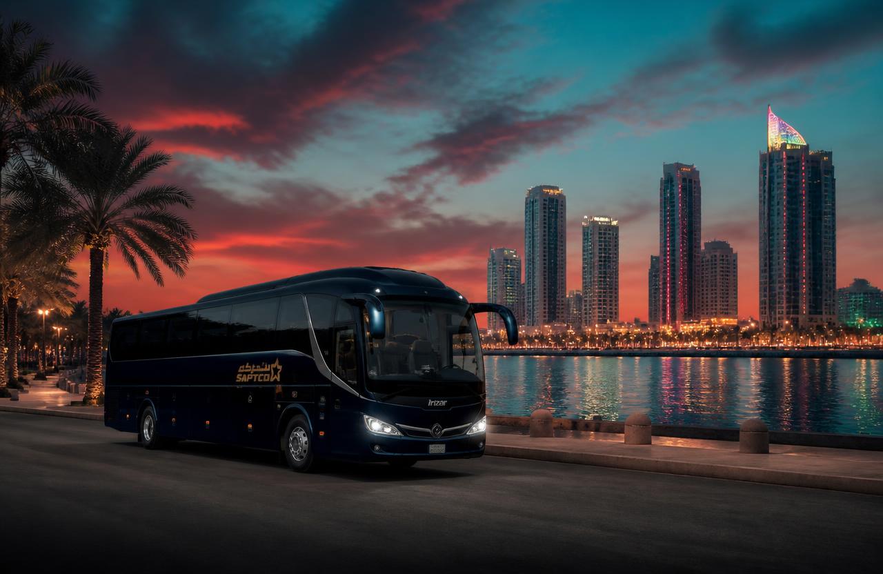 Bahrain Bus coach beside the Al Khobar corniche skyline at dusk